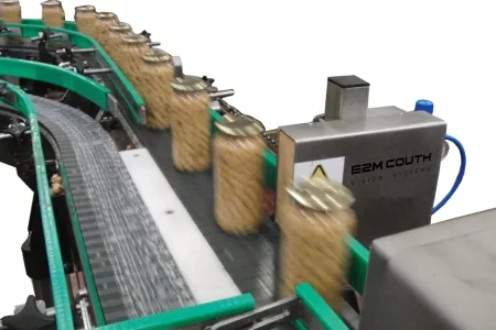 E2M Couth progressive rejection system displacing filled containers sideways off a conveyor